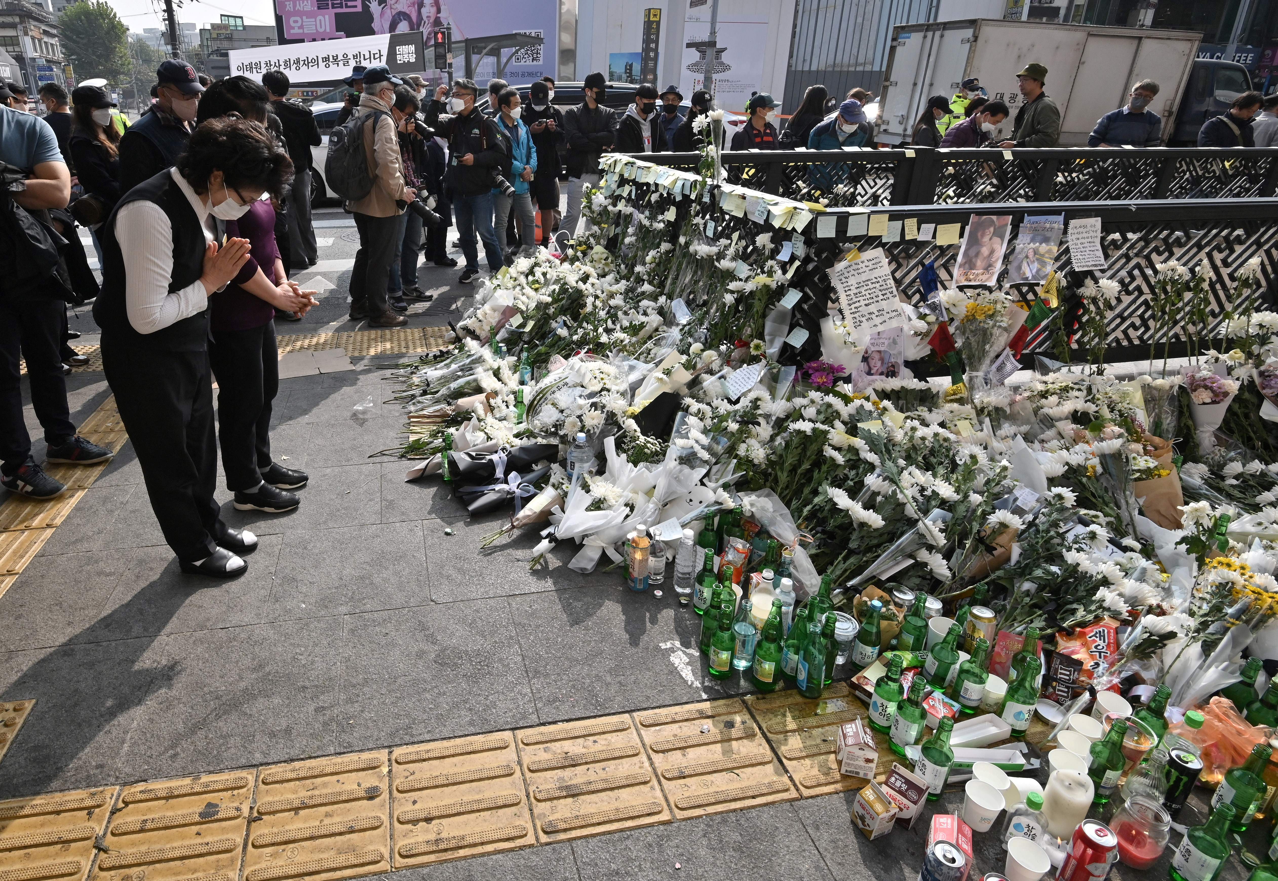 Mourners pay tributes at a makeshift memorial for the victims of the deadly Halloween crowd surge, outside a subway station in the district of Itaewon in Seoul