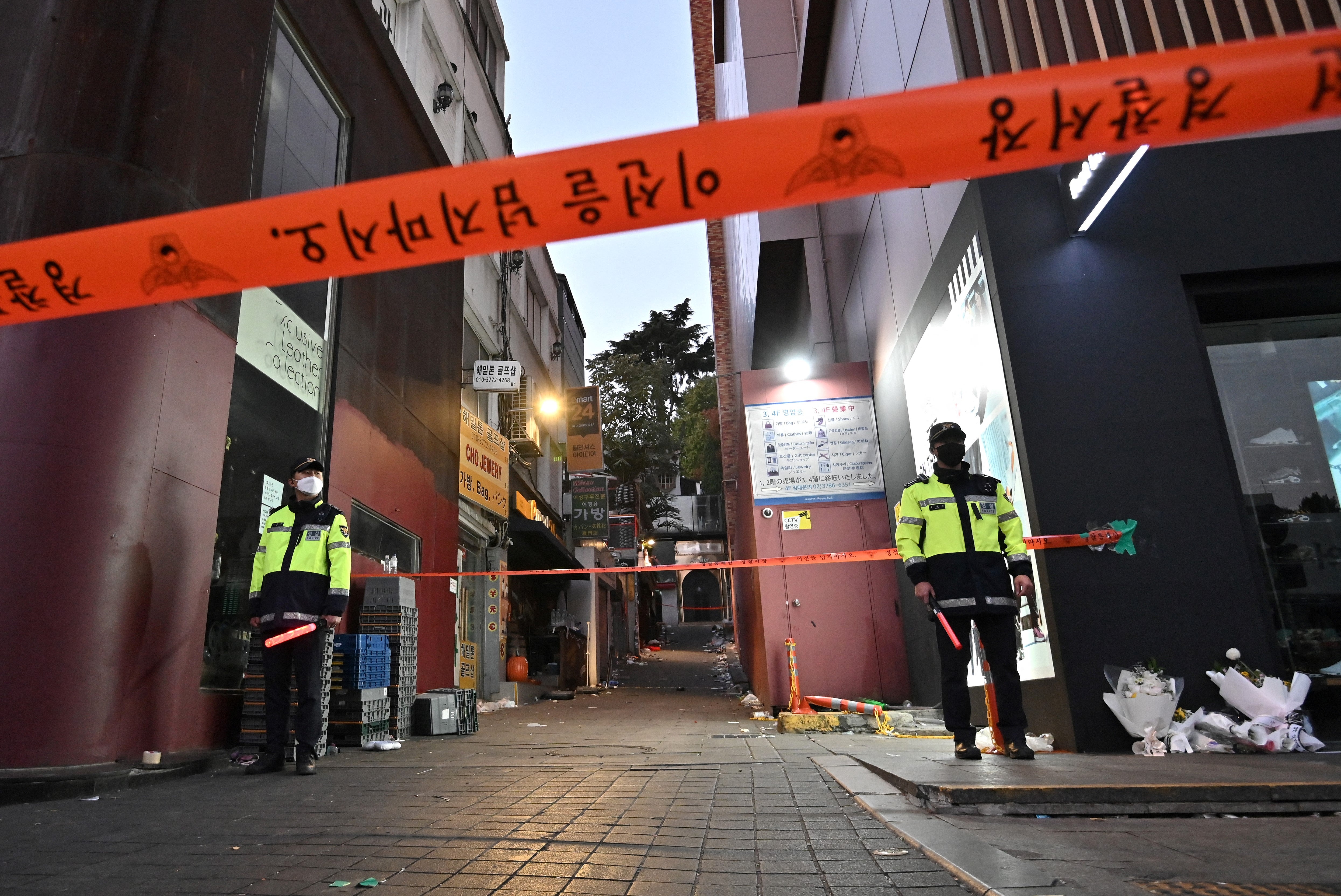 Police stand guard at the cordoned scene of the deadly Halloween crowd surge in the district of Itaewon in Seoul on 1 November 2022