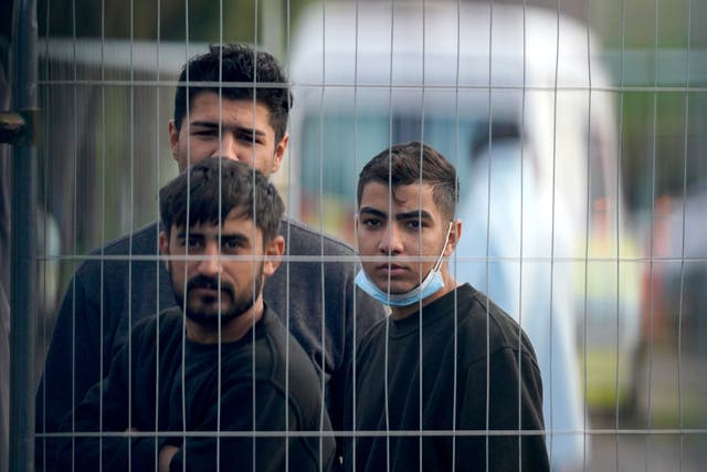 People thought to be migrants inside the Manston immigration short-term holding facility located at the former Defence Fire Training and Development Centre in Thanet, Kent (Gareth Fuller/PA)