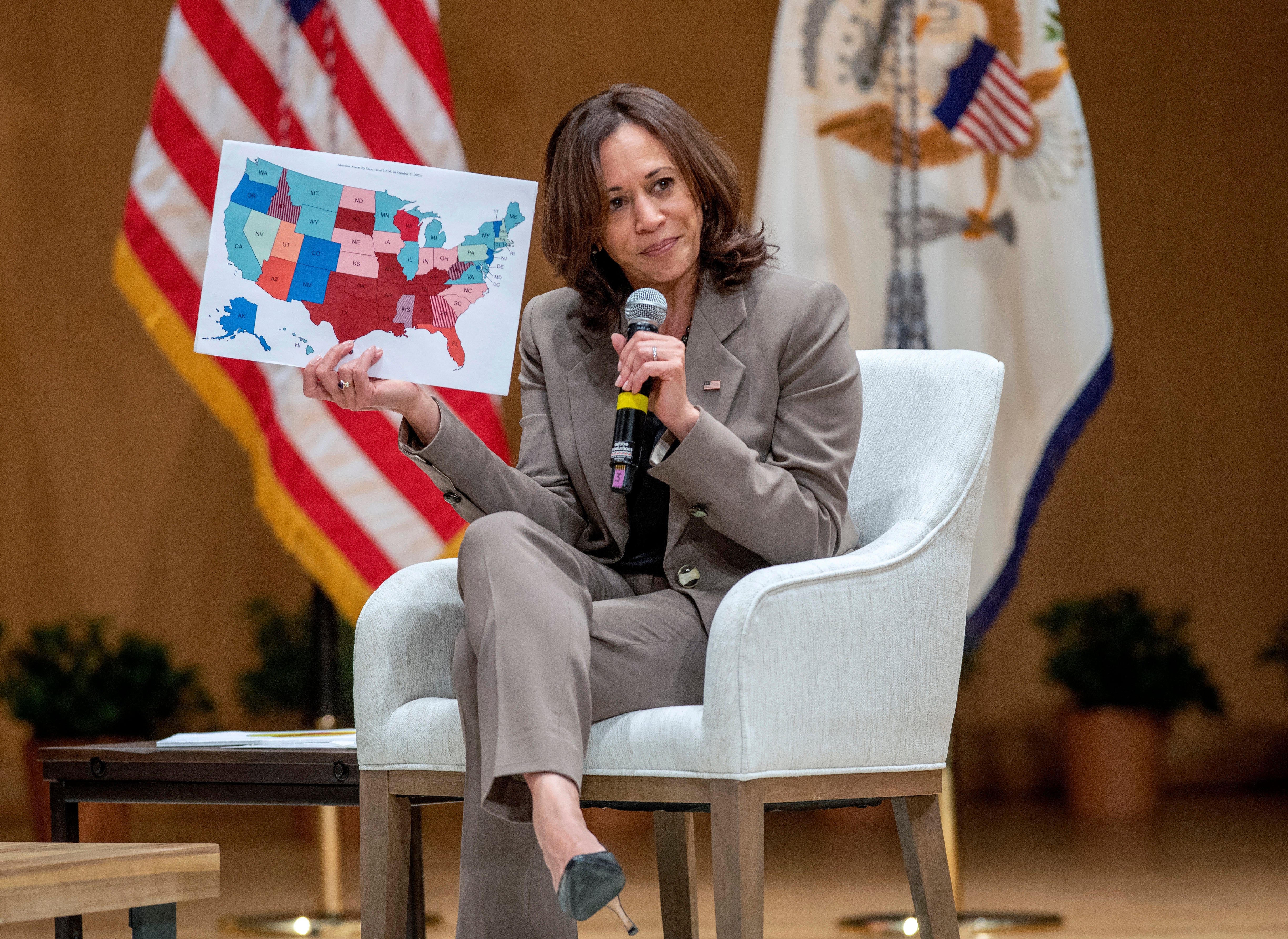 Kamala Harris holds up a map showing the inconsistency of abortion access in the US after the overturn of Roe v Wade