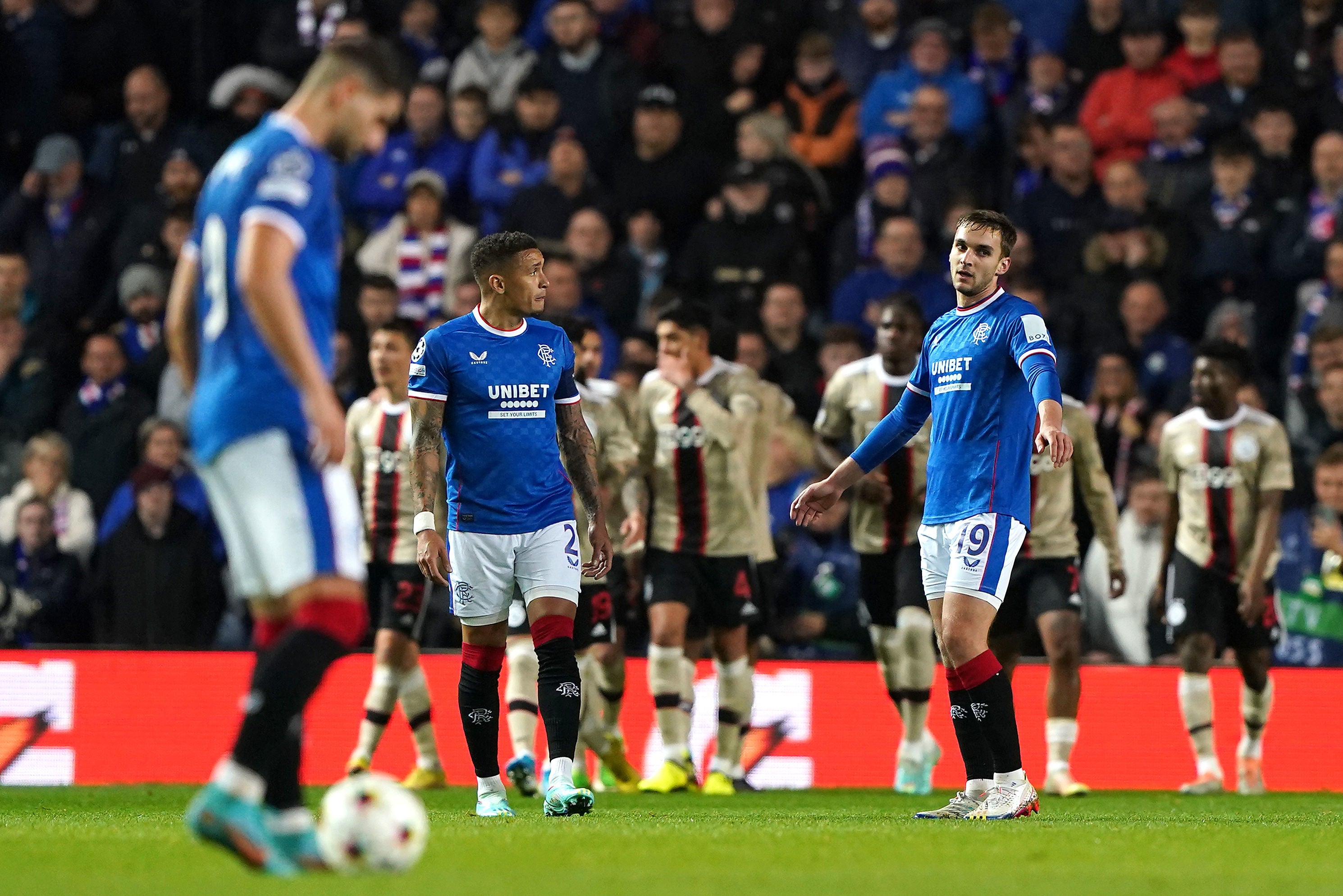 Rangers players look dejected after Ajax players celebrate their second goal