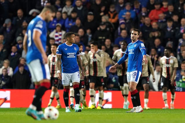 <p>Rangers players look dejected after Ajax players celebrate their second goal</p>