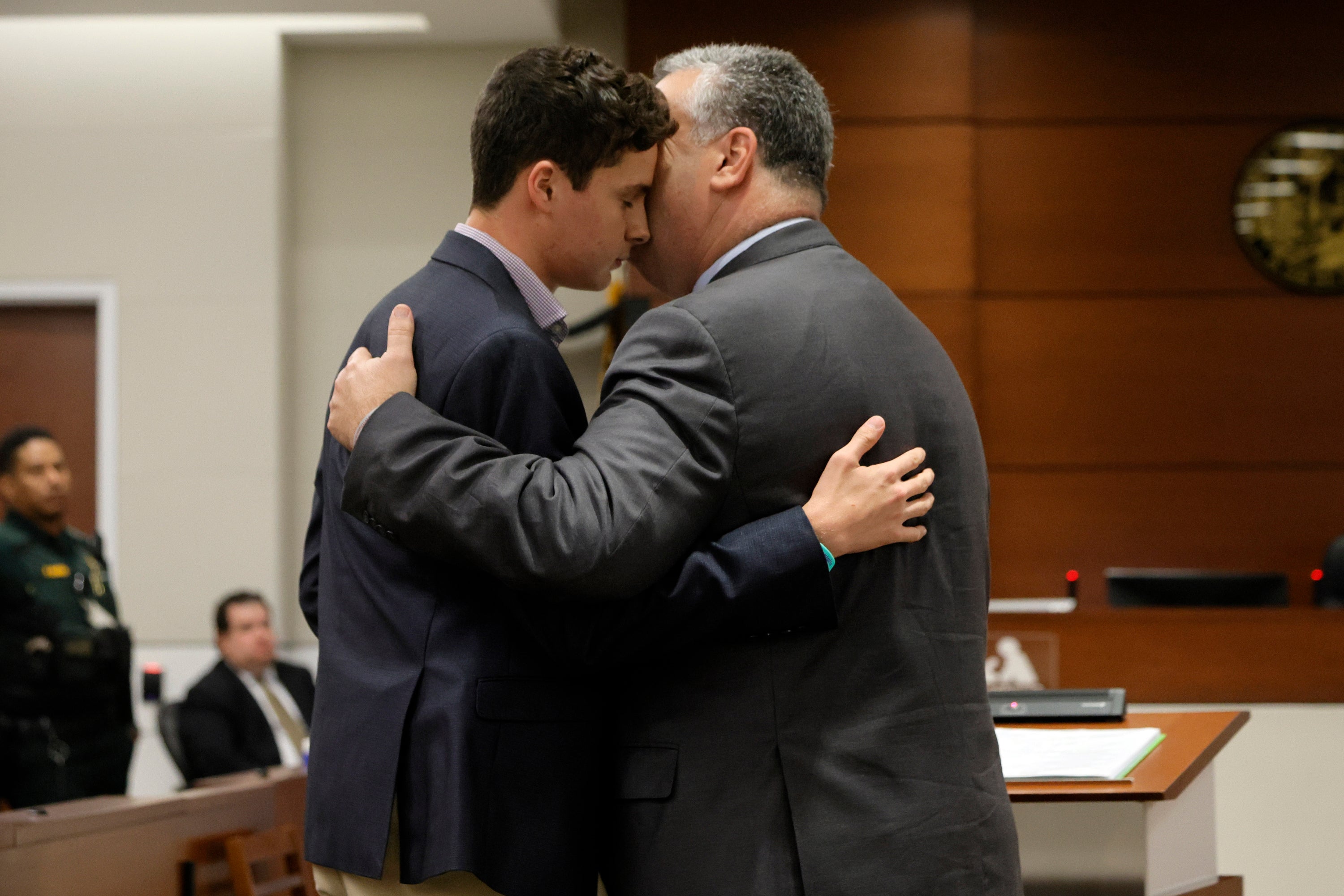 Tony Montalto embraces his son Anthony, after Anthony gave his victim impact statement about the murder of his sister Gina