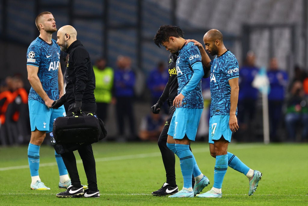 Son Heung-min receives medical attention during the win over Marseille (PA)