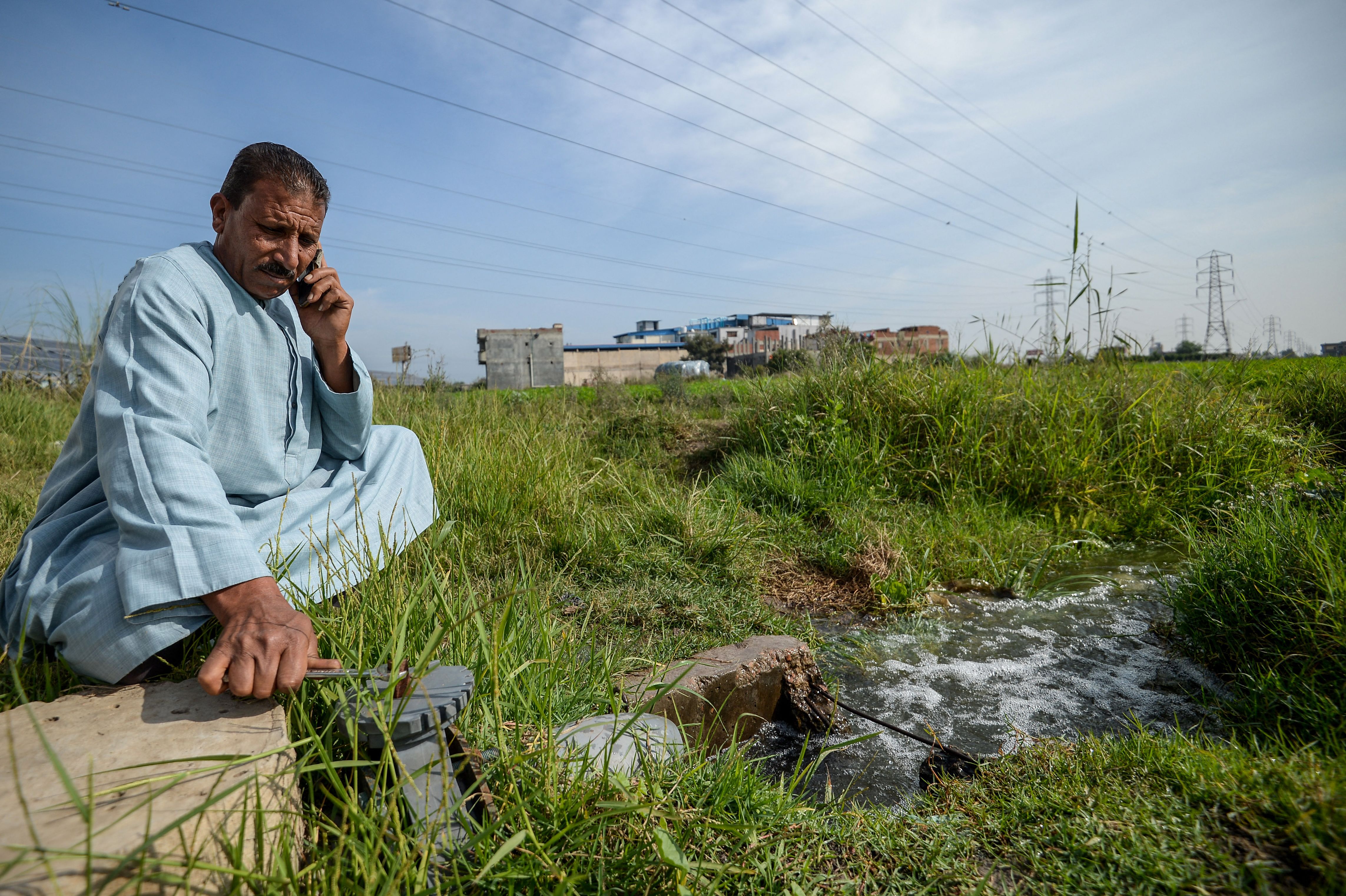 A farmer closes the water valve of a pump in Kafr al-Dawar village in northern Egypt’s Nile Delta