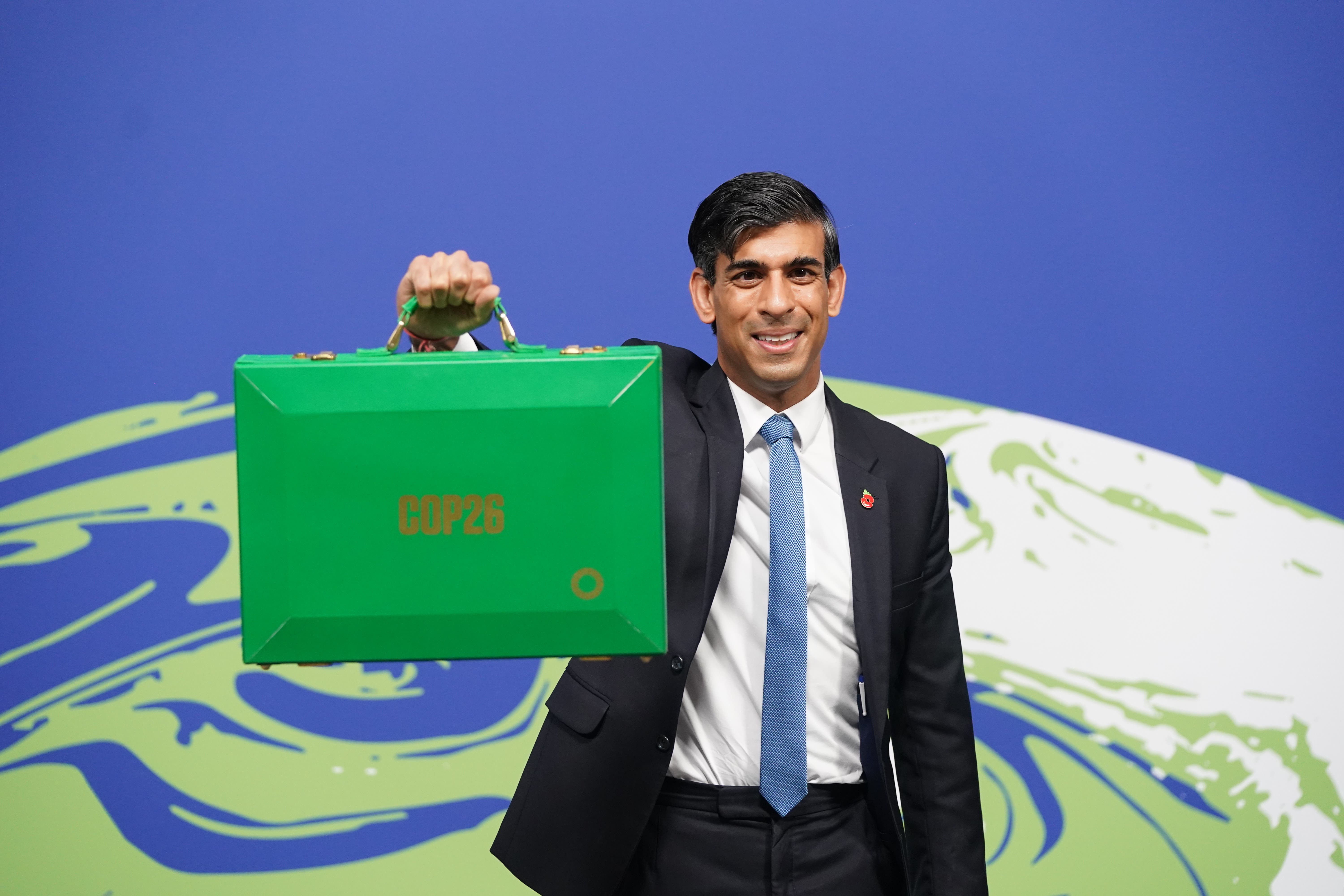 Rishi Sunak holds his Green Box at the Cop26 summit (Stefan Rousseau/PA)
