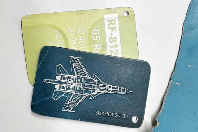 <p>A luggage tag made from scrap retrieved from a downed Russian fighter plane</p>