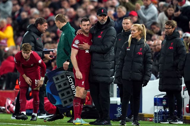 Liverpool manager Jurgen Klopp embraces James Milner after the player was substituted during the Champions League match against Napoli (Nick Potts/PA)