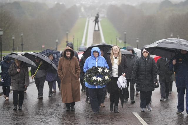 Dympna Kerr (centre) carries a wreath with Irish Senator Emer Currie (centre right) (Niall Carson/PA)