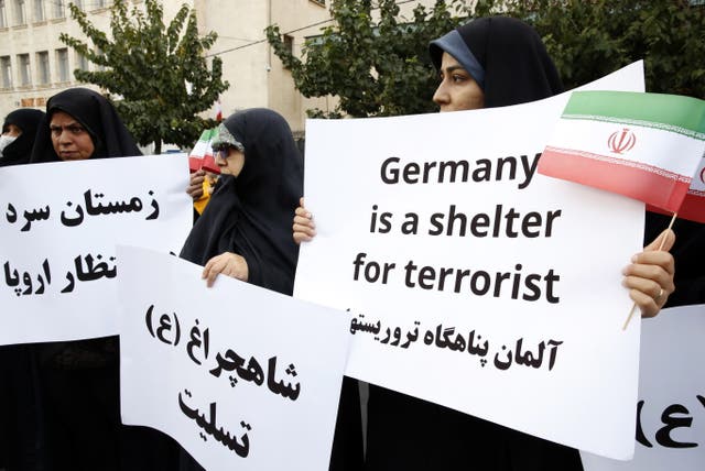 <p>Iranians take part during an anti-Germany protest in front of the German embassy in Tehran on Tuesday</p>