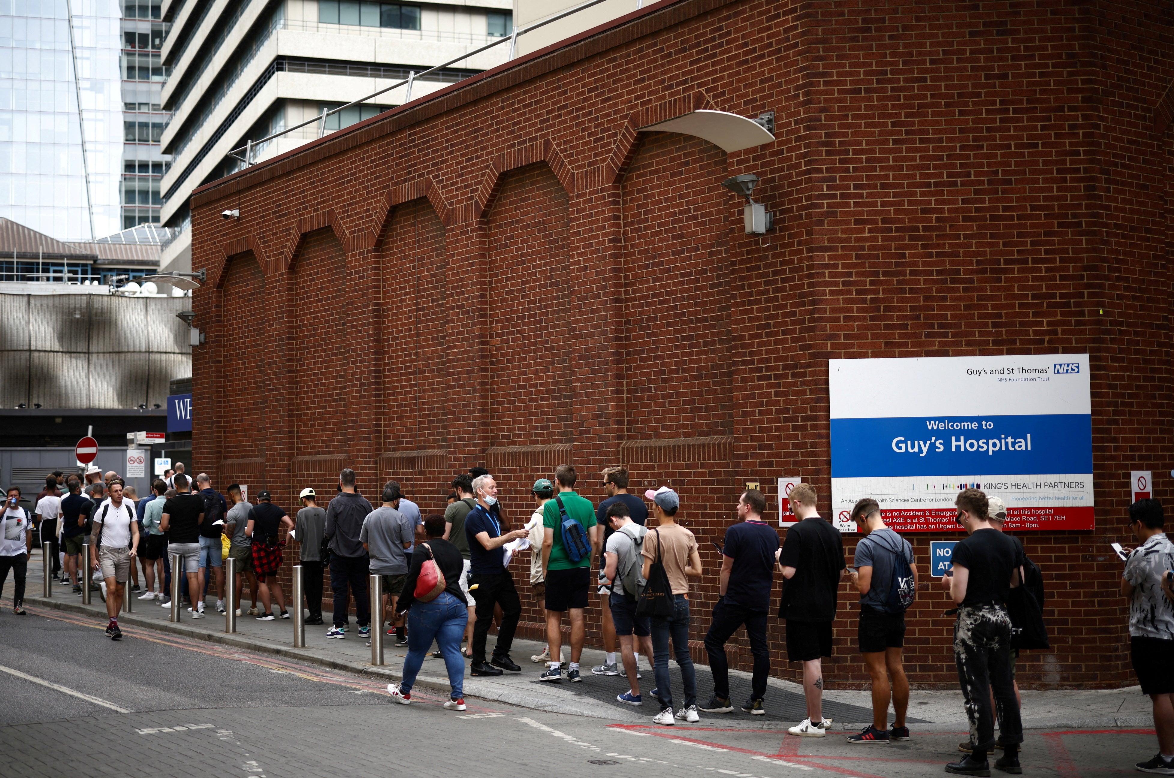 People queue up to receive monkeypox vaccinations at Guy’s Hospital in London