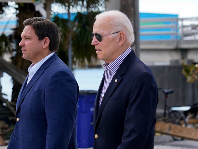 <p>President Joe Biden, right, and Florida Governor Ron DeSantis (left) in Fort Myers Beach on 5 October 2022</p>