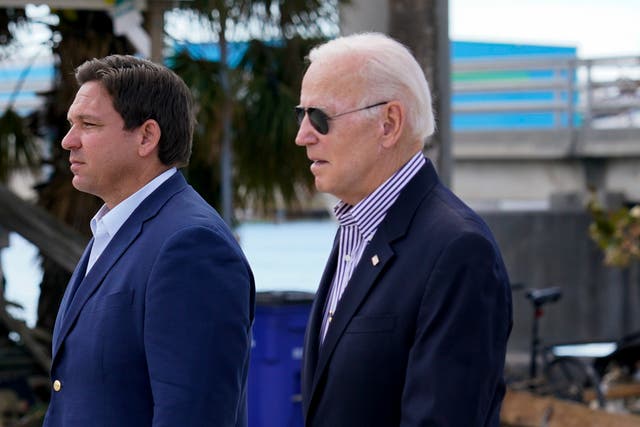 <p>President Joe Biden, right, and Florida Governor Ron DeSantis (left) in Fort Myers Beach on 5 October 2022 after Hurricane Ian </p>