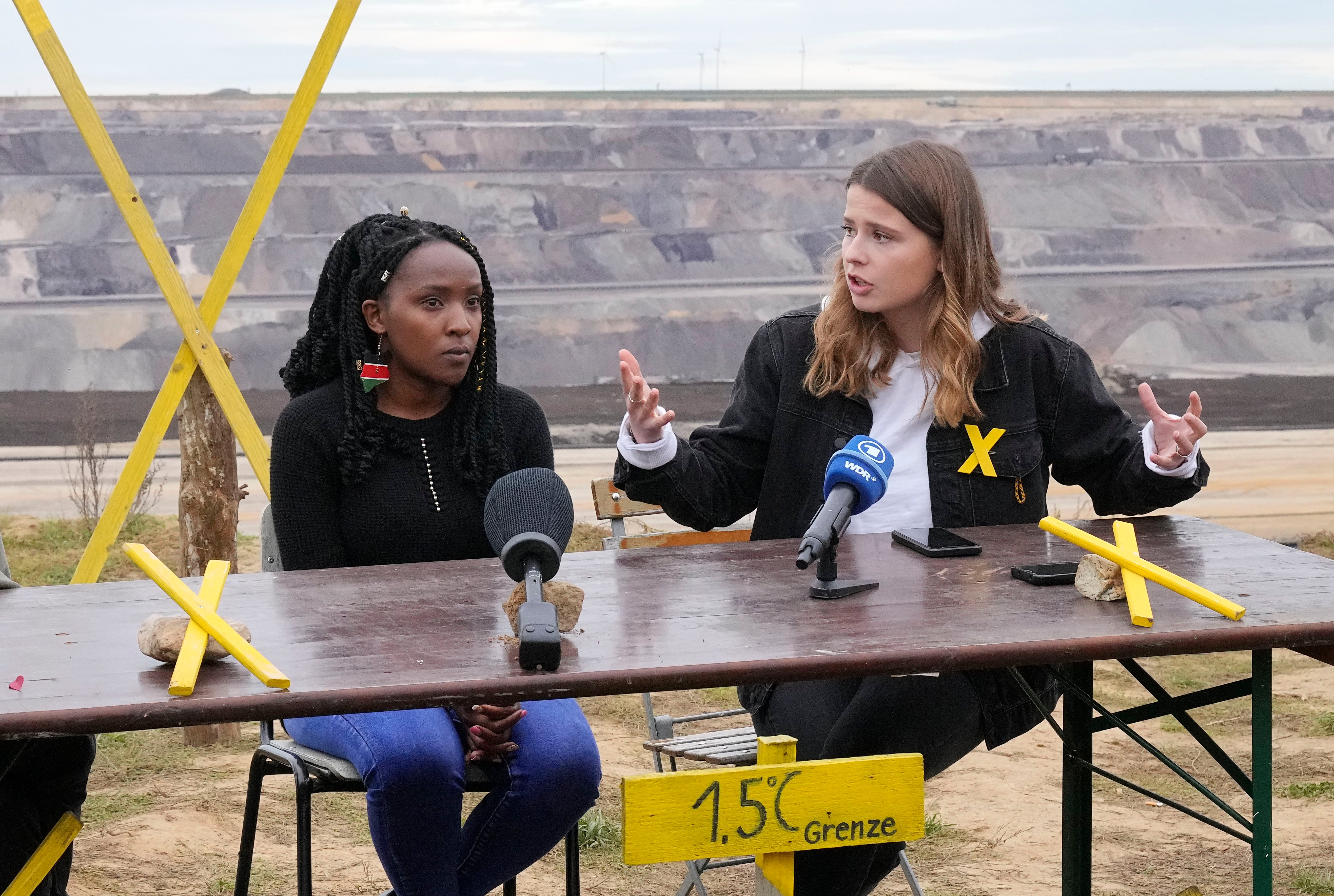 Elizabeth Wathuti (right) with fellow activist Luisa Neubauer at a news conference at the Garzweiler open-cast coal mine near Luetzerath, western Germany, in October