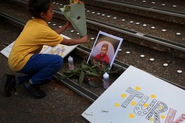 <p>A young girl lays flowers during a vigil in honour of Cassius Turvey at Town Hall on 2 November 2022 in Sydney, Australia</p>