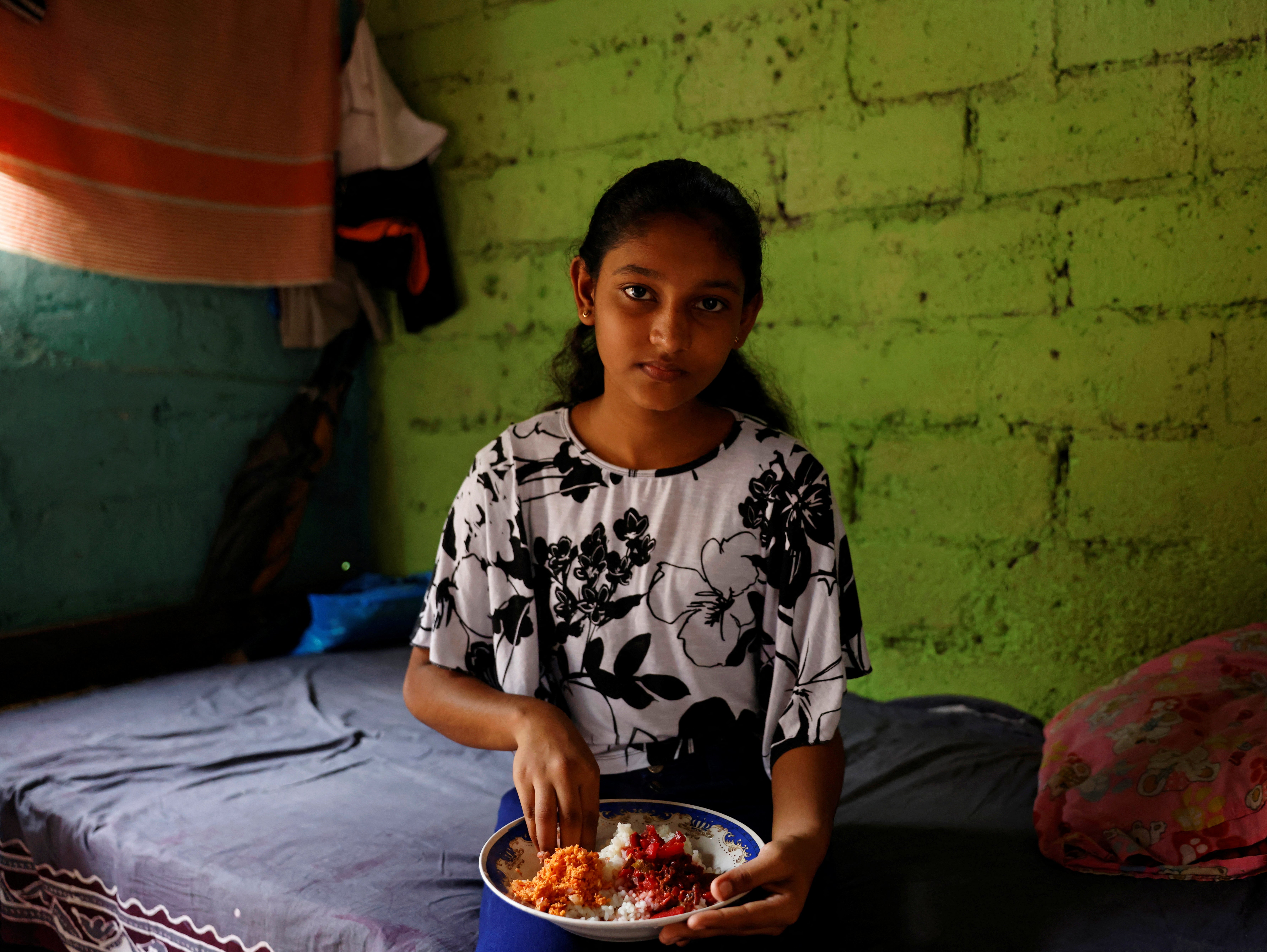 Dilhani Wathsala, 14, with her lunch. ‘Before the economic crisis, we ate well and we served meat or fish to our kids at least three or four times a week. Now fish is out of the reach of our family and so is meat,’ says her mother