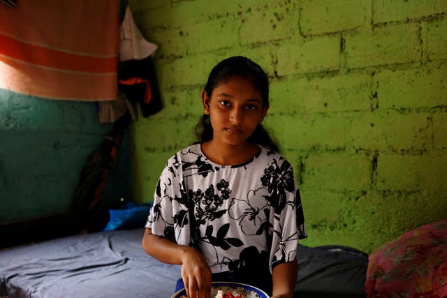 <p>Dilhani Wathsala, 14, with her lunch. ‘Before the economic crisis, we ate well and we served meat or fish to our kids at least three or four times a week. Now fish is out of the reach of our family and so is meat,’ says her mother</p>