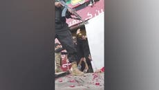 Imran Khan waves to supporters after being shot in the leg in ‘assassination attempt’