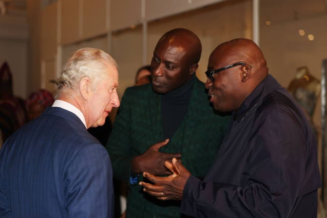 The King peaks to fashion designer Ozwald Boateng, OBE (left) and Edward Kobina Enninful OBE (Ian Vogler/Daily Mail/PA)