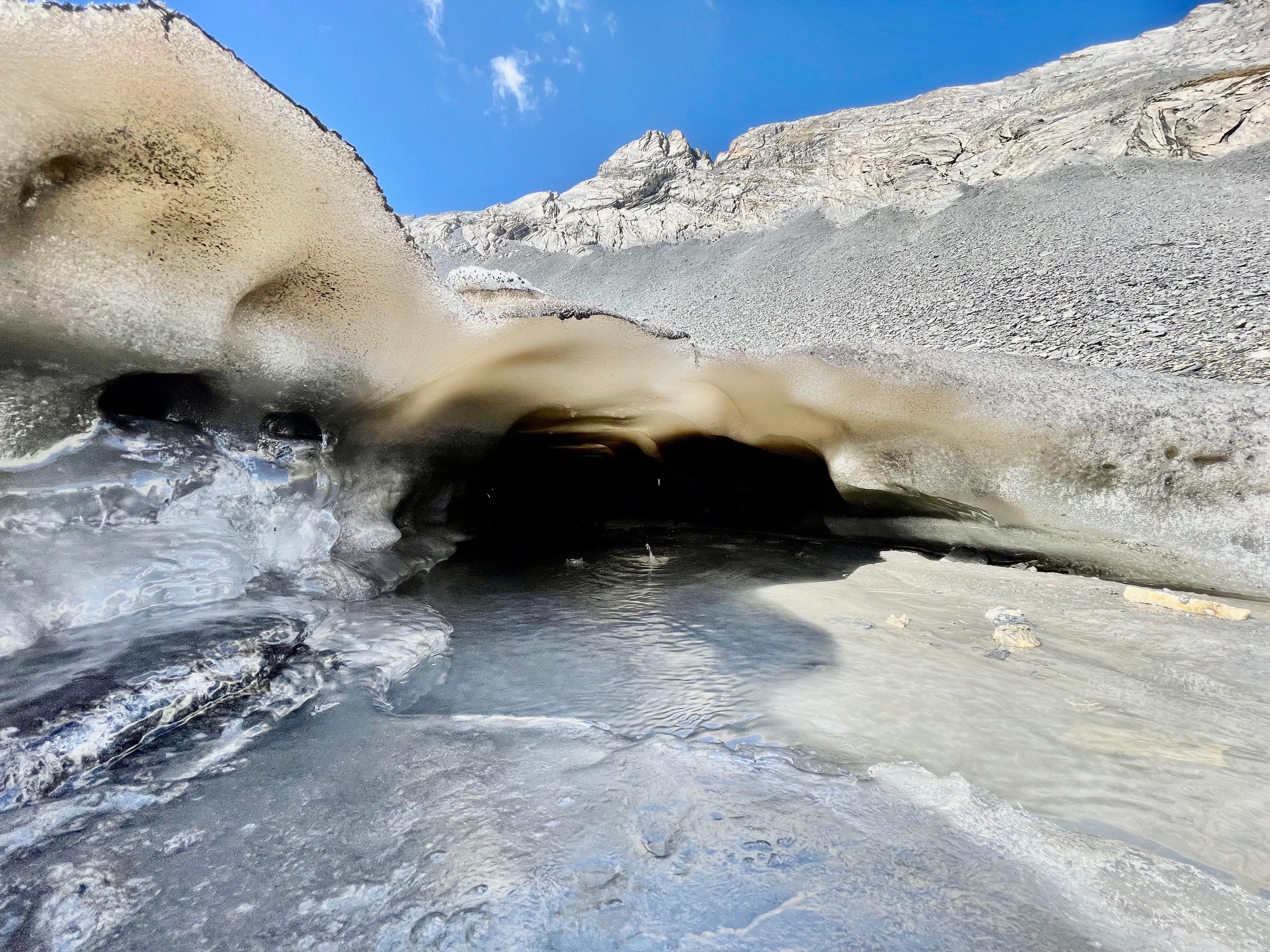 A meltwater stream flows from beneath the Forcle Glacier near Chamoson, Switzerland