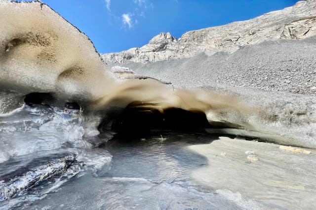 <p>A meltwater stream flows from beneath the Forcle Glacier near Chamoson, Switzerland</p>