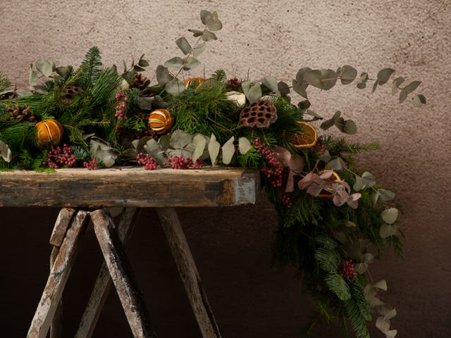 <p>Dry cut oranges and apples onto wire or string to create an organic garland </p>