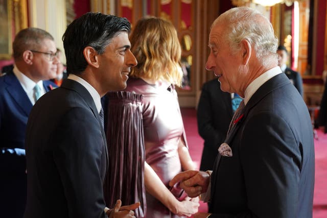 The King speaks with Prime Minister Rishi Sunak during the reception at Buckingham Palace (Jonathan Brady/PA)