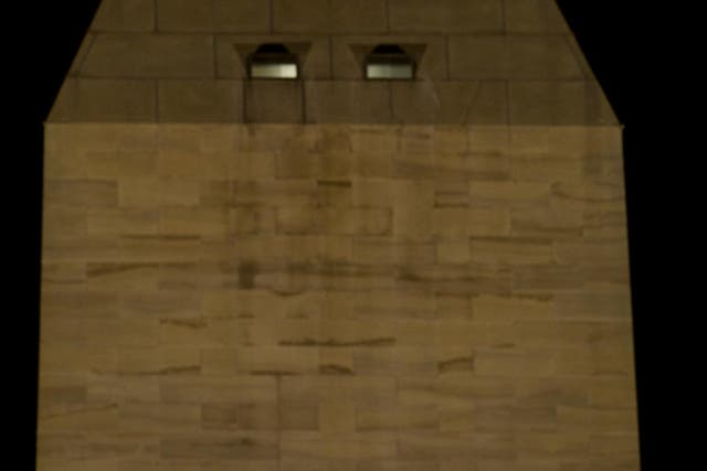 <p>A total lunar eclipse is seen in the sky above the Washington Monument in Washington, D.C., in 2010</p>