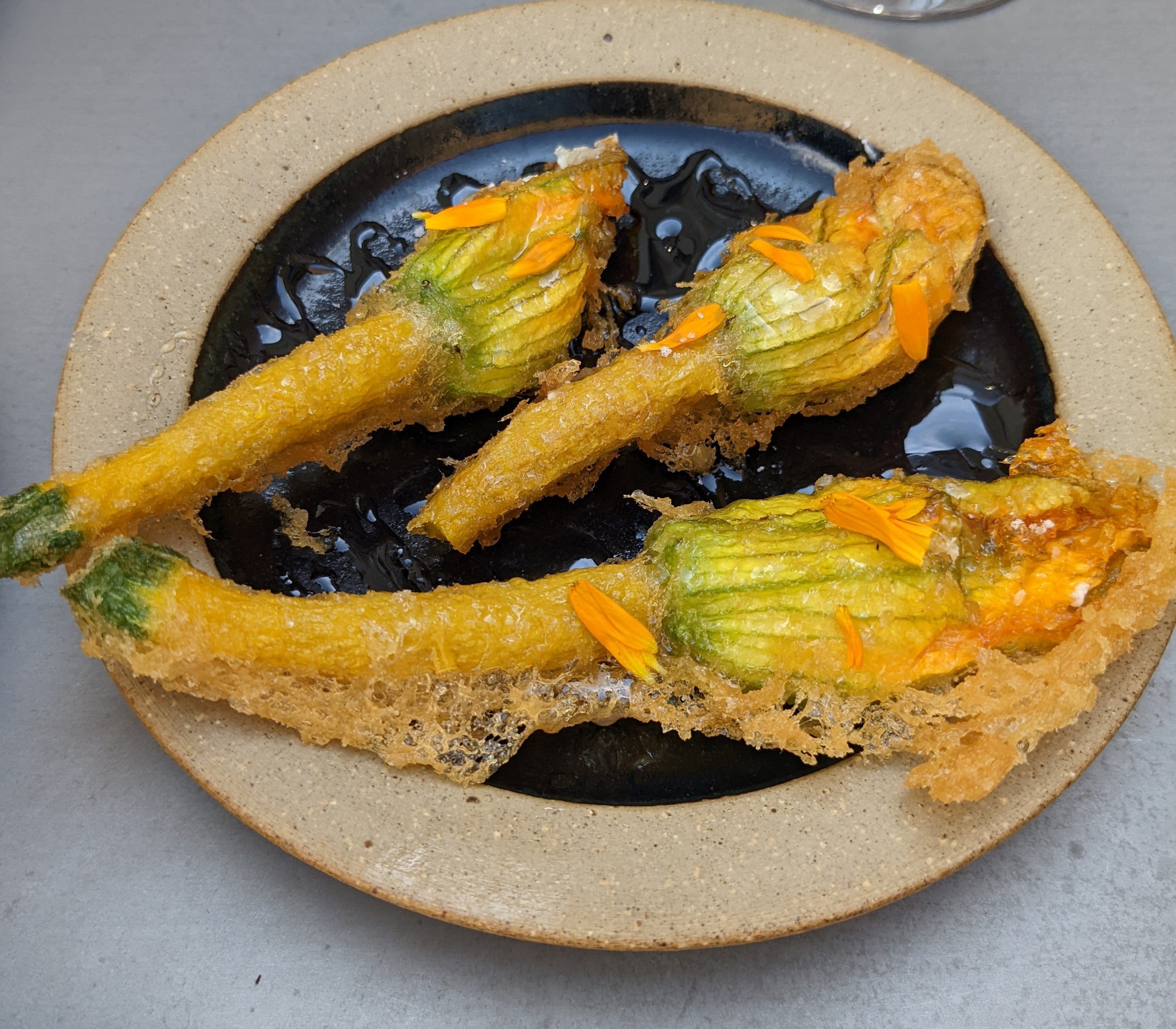 Stuffed squash flowers are delicately sweet, thanks to a drizzle of local honey
