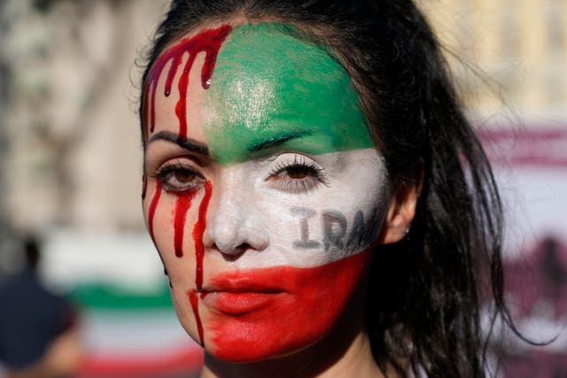 <p>Woman protests against the death of Mahsa Amini, a woman who died while in police custody in Iran, during a rally in Rome</p>