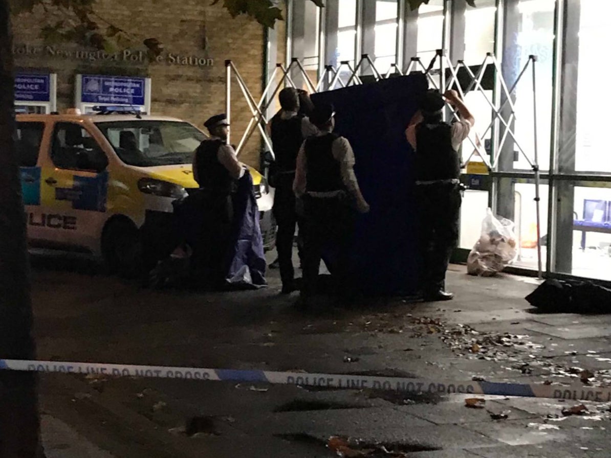 Officers create a tent outside the station