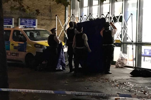 <p>Officers create a tent outside the station</p>