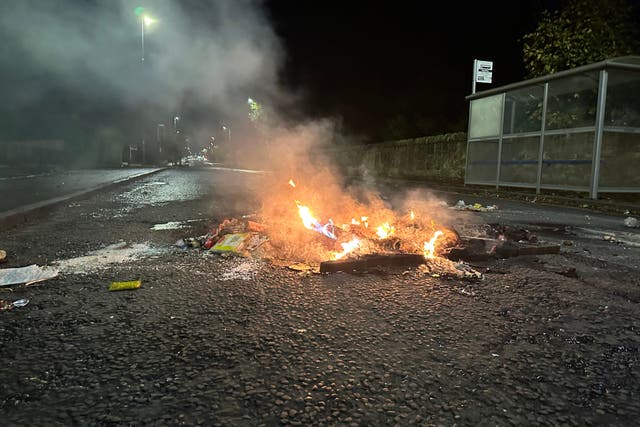 The remains of a fire which blocked Niddrie Mains Road, Edinburgh, to traffic (Dan Barker/PA)