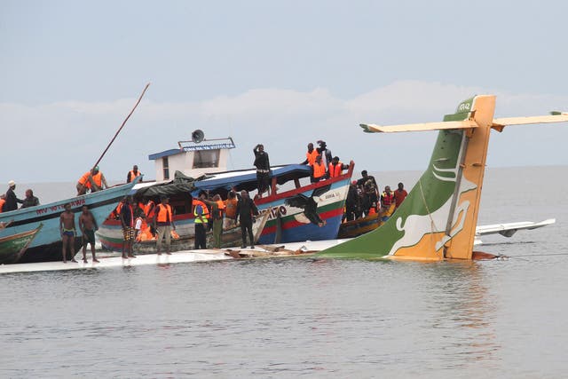 <p>Passengers are taken to safety from the jet in the lake </p>