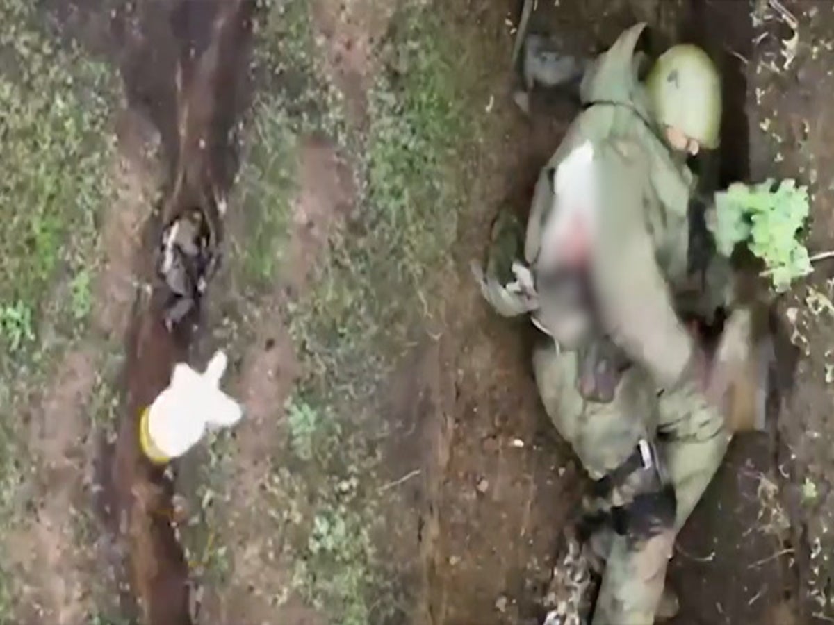 A shell-shocked Ukrainian soldier in a trench is getting taken