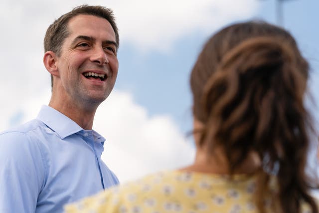 <p>US Senator Tom Cotton speaks with a supporter at a Herschel Walker campaign event on 11 October 2022 in Carrollton, Georgia </p>