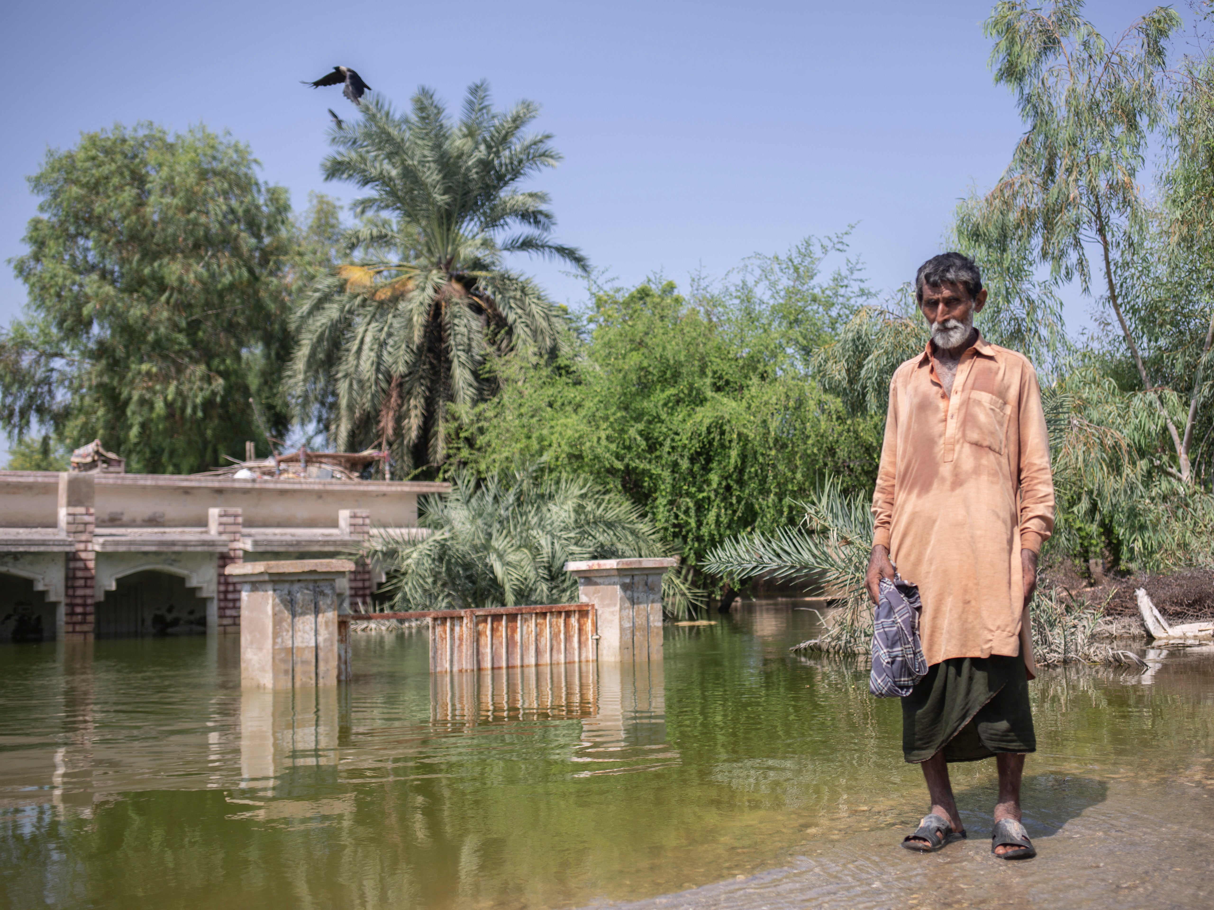 Ali Sher Langah lives in his village despite being surrounded with water as he didn't want to leave his house