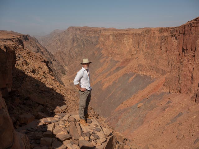 <p>Dr Paul Marshall stands at the precipice of a ravine in the NEOM reserve </p>