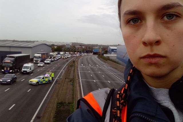 <p>A protester climbed a gantry on the M25 between junctions six and seven in Surrey, leading to the closure of the motorway on  Monday </p>
