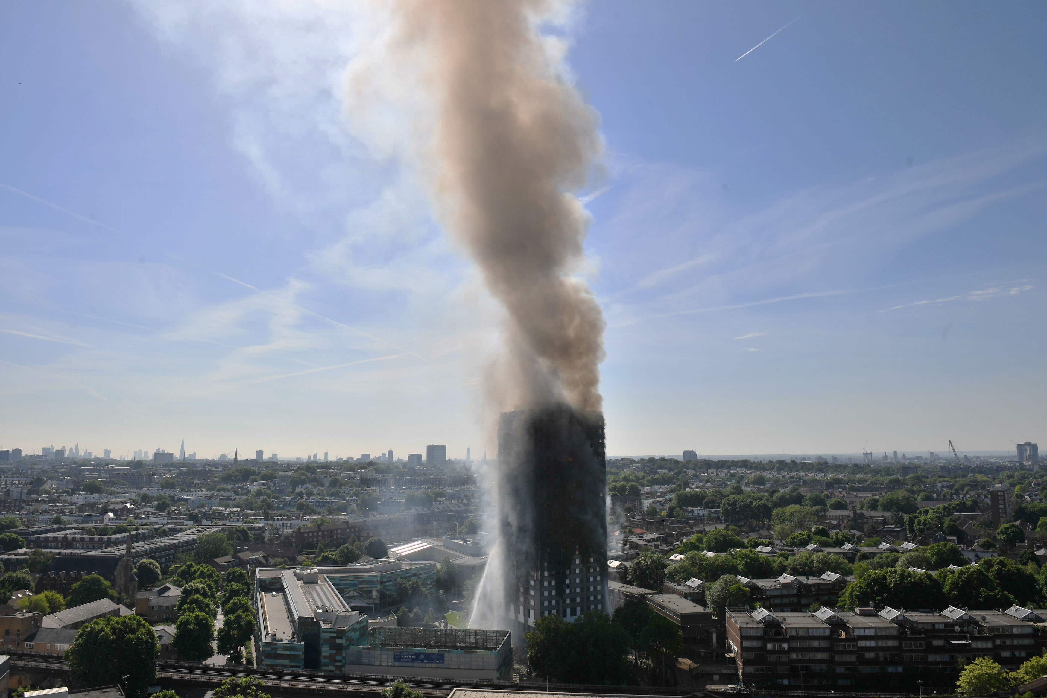 Smoke billows from the tower after the fire