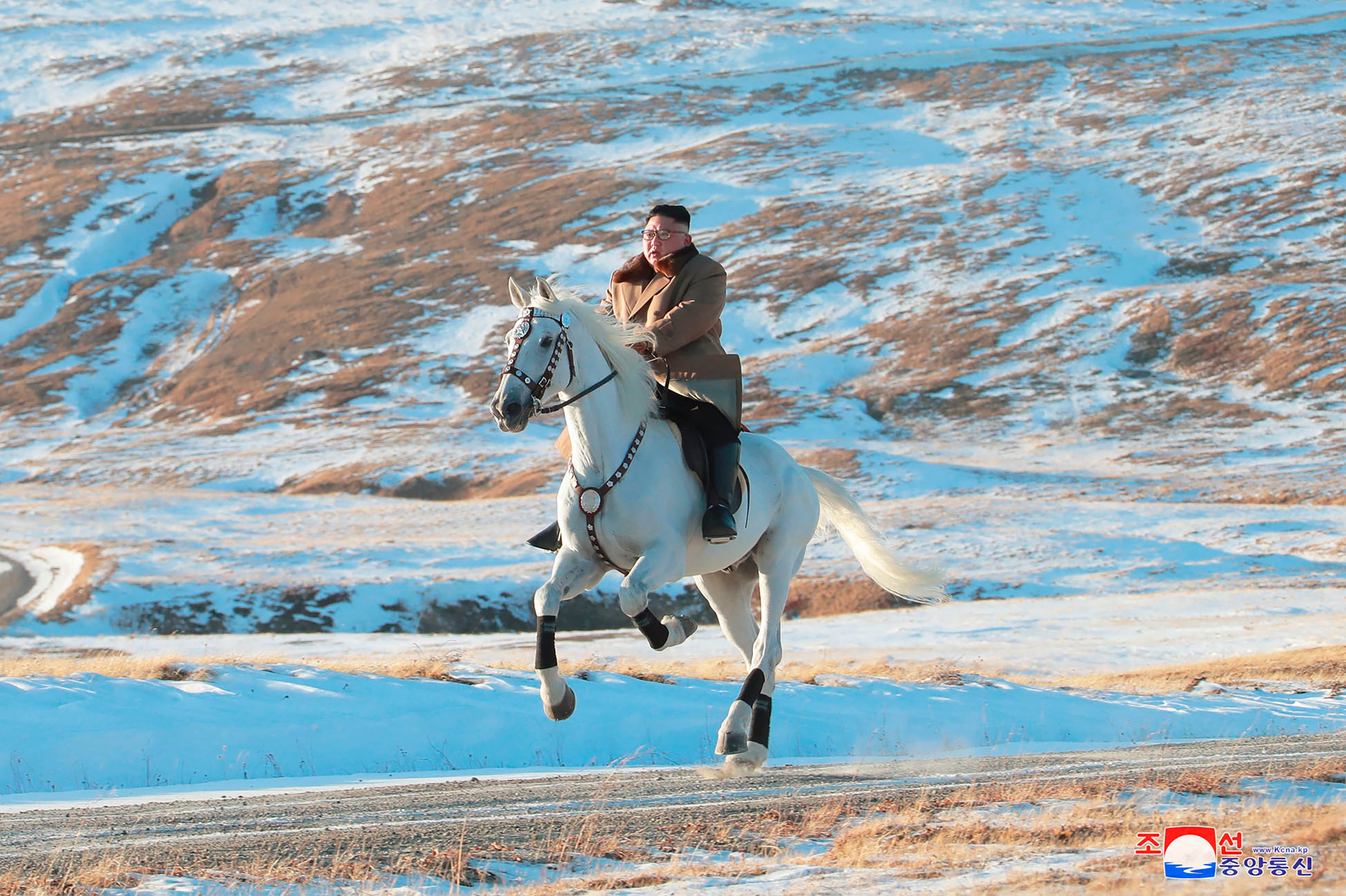 North Korean leader Kim Jong-un rides a white horse to climb Mount Paektu, North Korea in undated photo