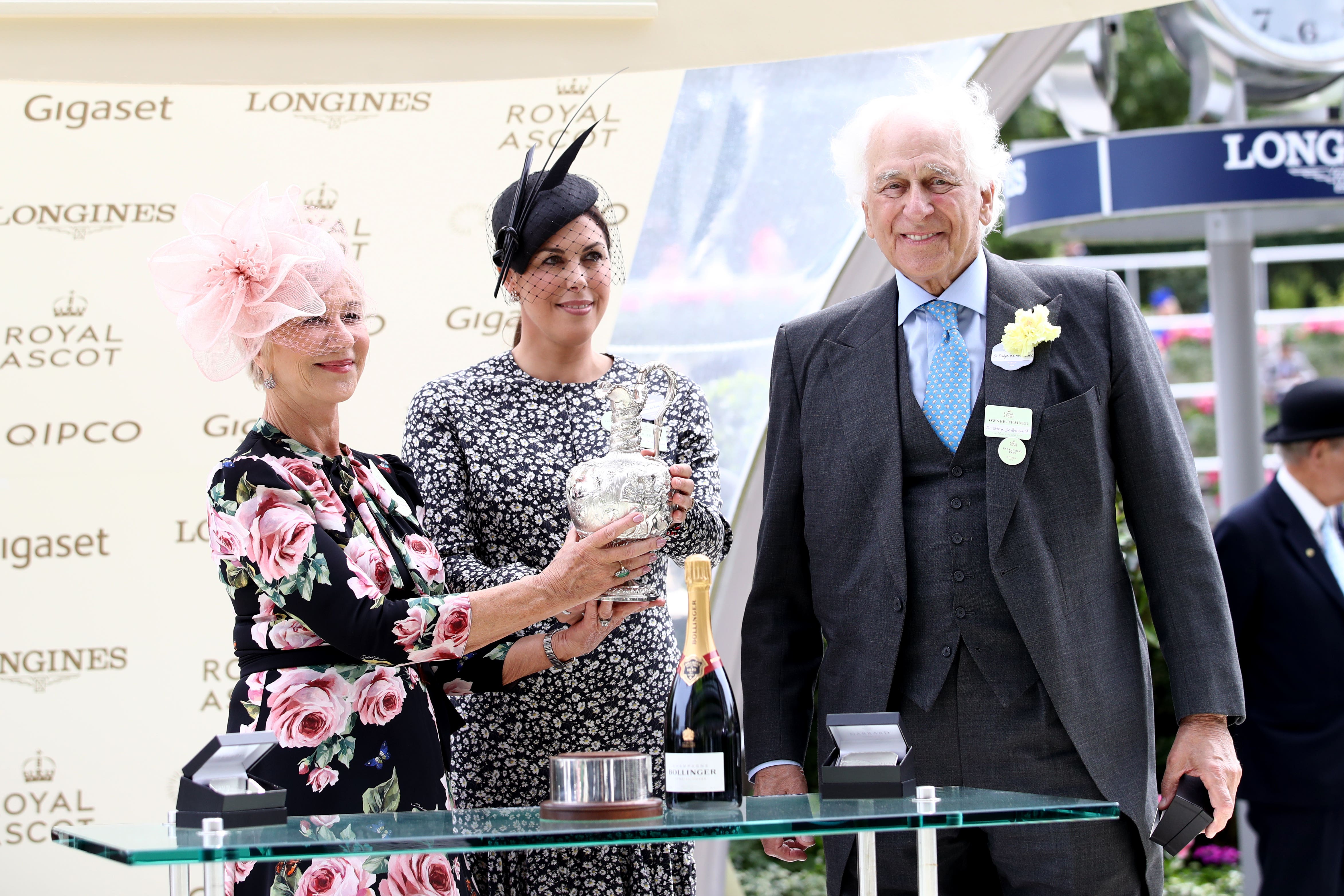 Dame Helen Mirren presents owner Sir Evelyn de Rothschild (right) and Jessica de Rothschild with a trophy after Crystal Ocean wins the Hardwicke Stakes during day five of 2018 Royal Ascot at Ascot Racecourse (John Walton/PA)