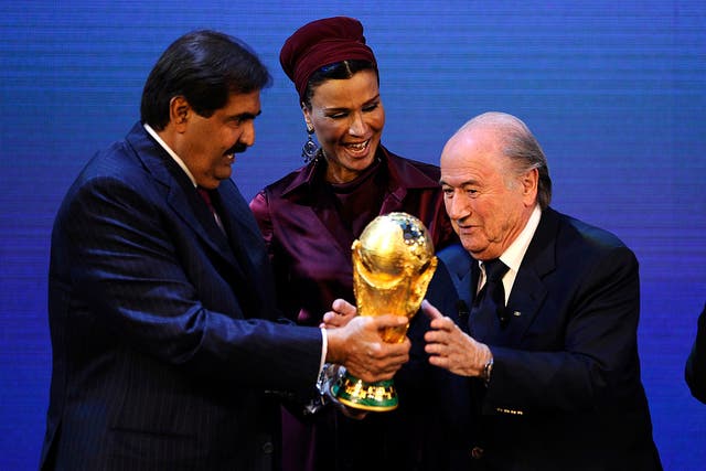 <p>Sepp Blatter hands over the World Cup trophy to the Emir of Qatar Sheikh Hamad bin Khalifa Al-Thani in 2010</p>
