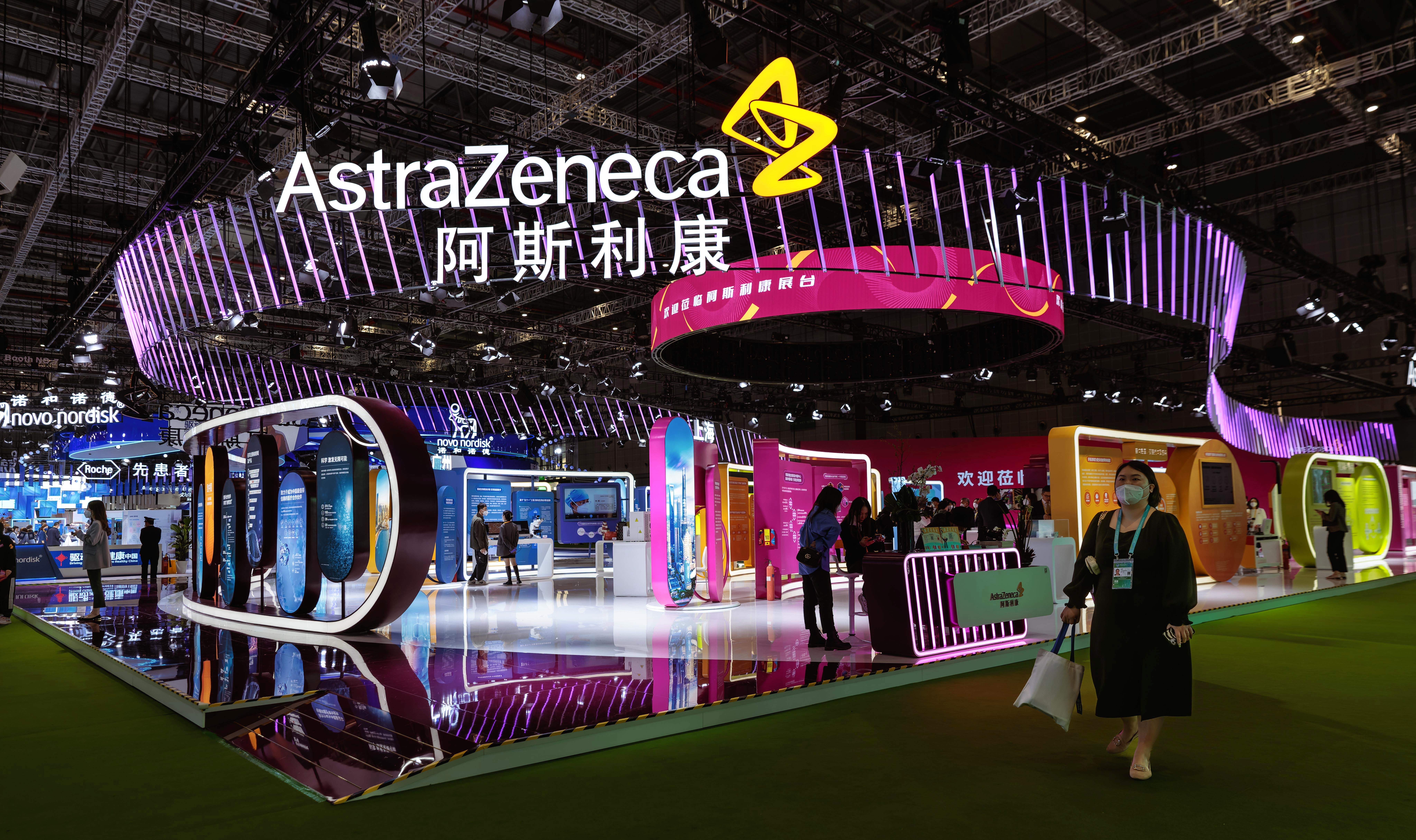 <p> A woman walks in front of the Astra Zeneca company booth during the China International Import Expo in Shanghai, China, 7 November 2022. </p>