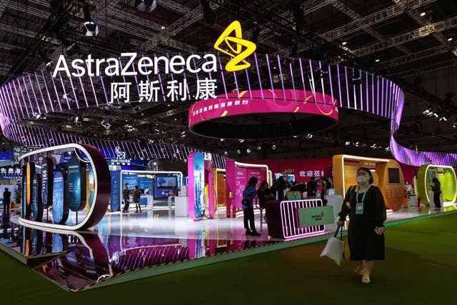 <p> A woman walks in front of the Astra Zeneca company booth during the China International Import Expo in Shanghai, China, 7 November 2022. </p>