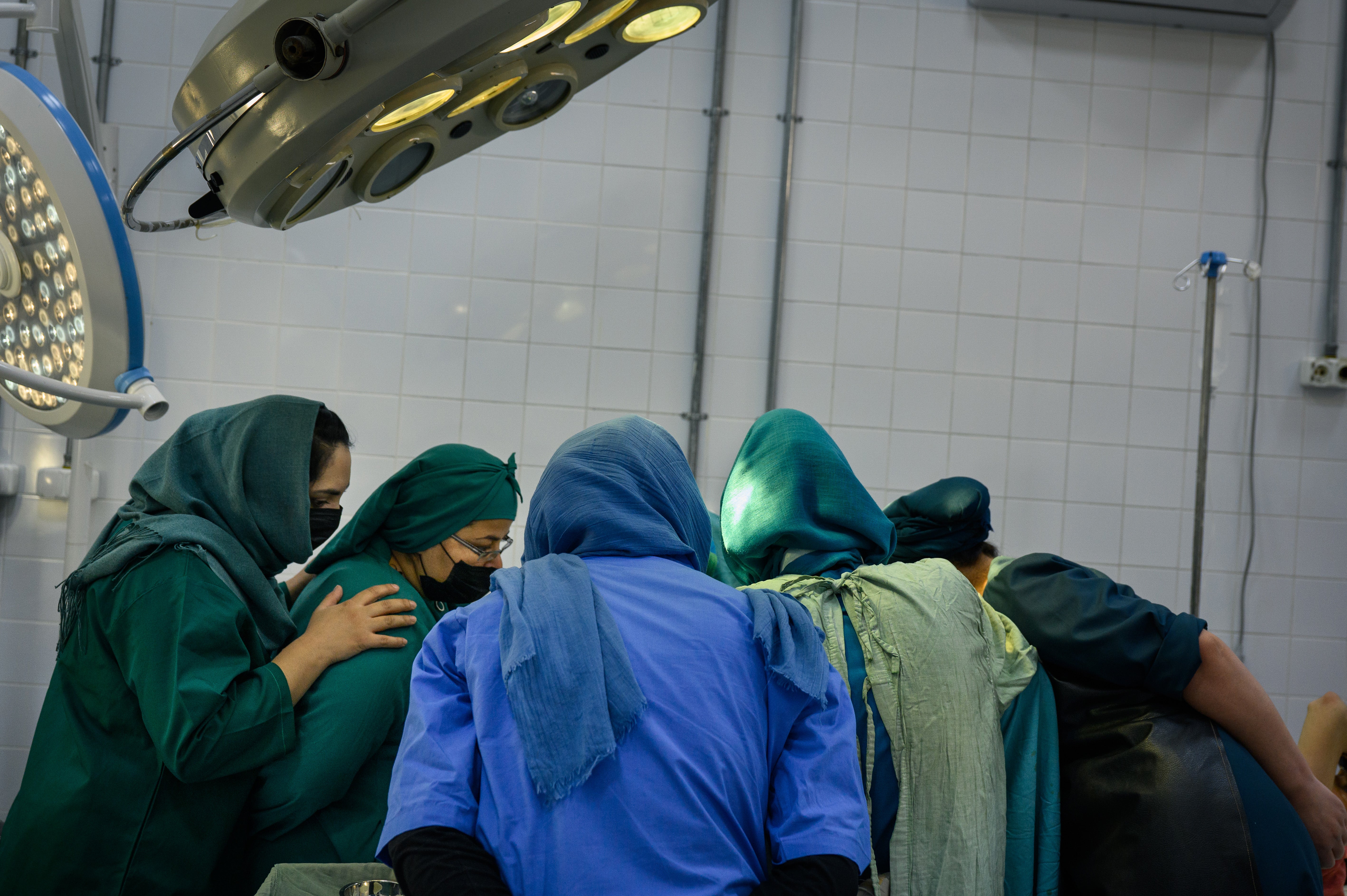 Residents watch and assist during a C-section