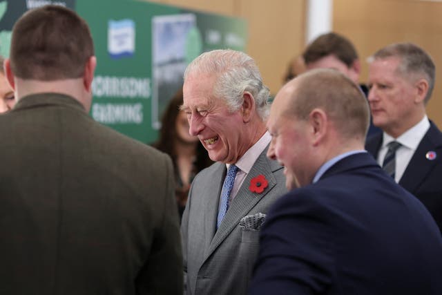 The King laughs during a visit to the head office of Morrisons in Bradford (Russell Cheyne/PA)