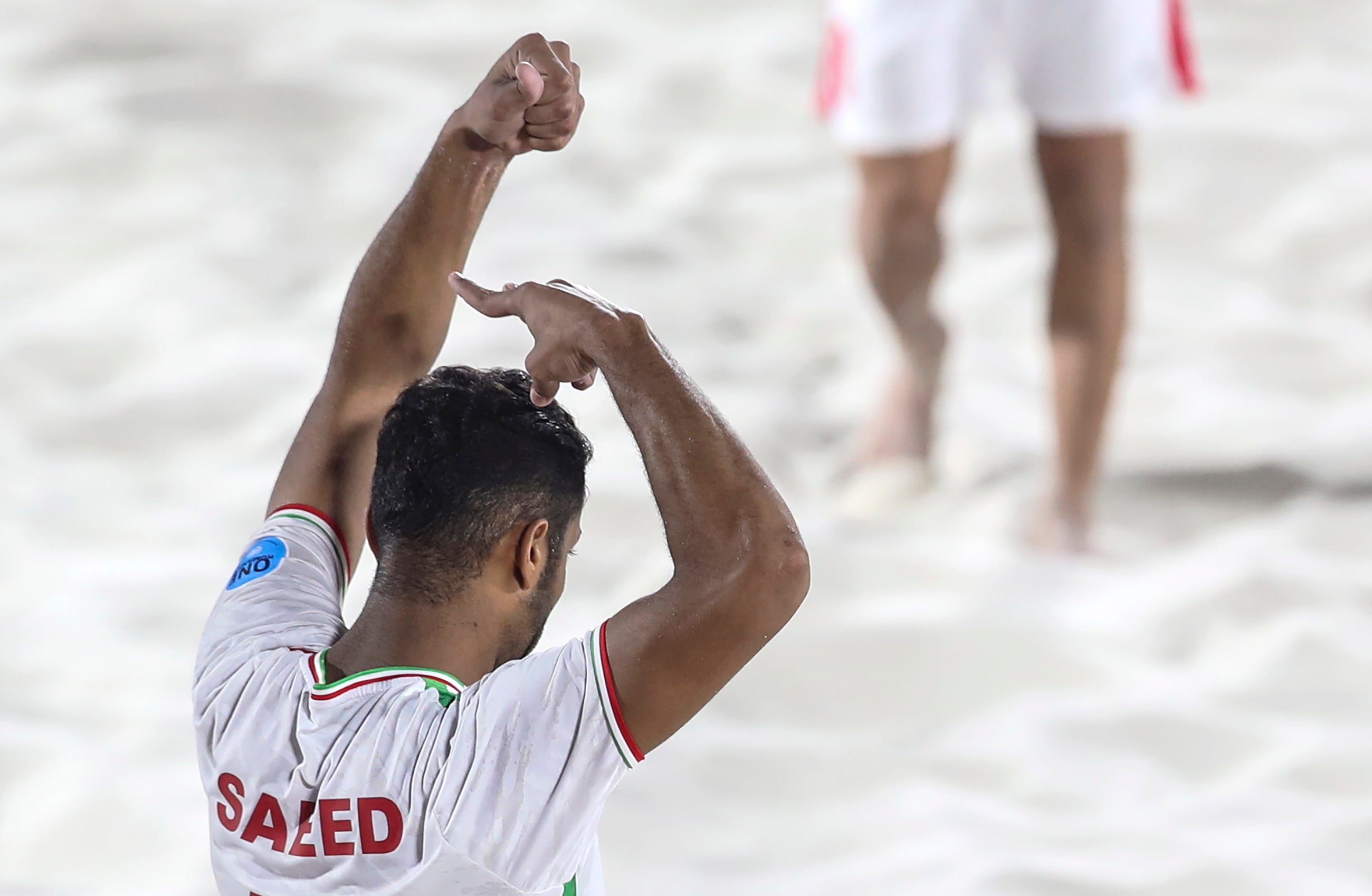 Saeed Piramoun of Iran celebrates after scoring a goal in the Emirates Intercontinental Beach Soccer Cup 2022 final match between Brazil and Iran in Dubai, by pretending to cut his hair in sympathy with protesters
