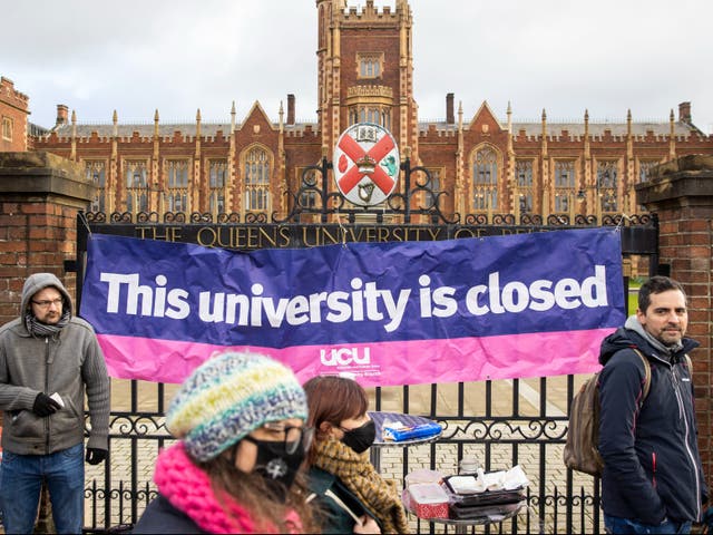 <p>UCU banner hangs from the gates of Queen’s University Belfast during strikes last February</p>