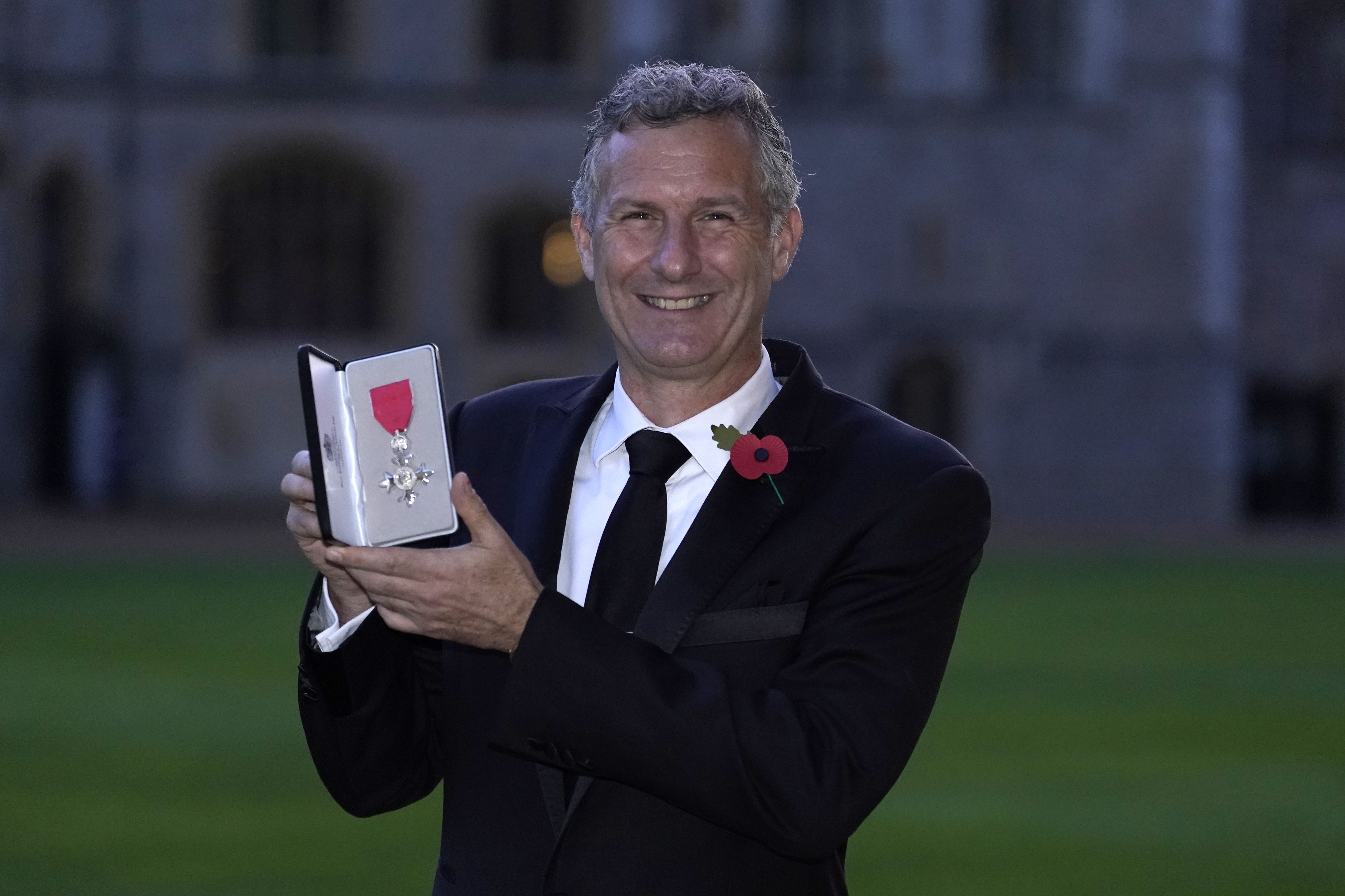 Adam Hills after being made a MBE (Andrew Matthews/PA)
